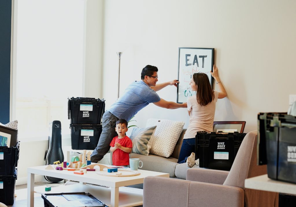 What to ask when choosing a moving company - Couple hanging a picture