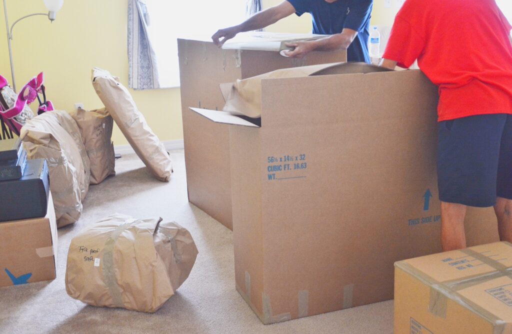 two men packing for a move