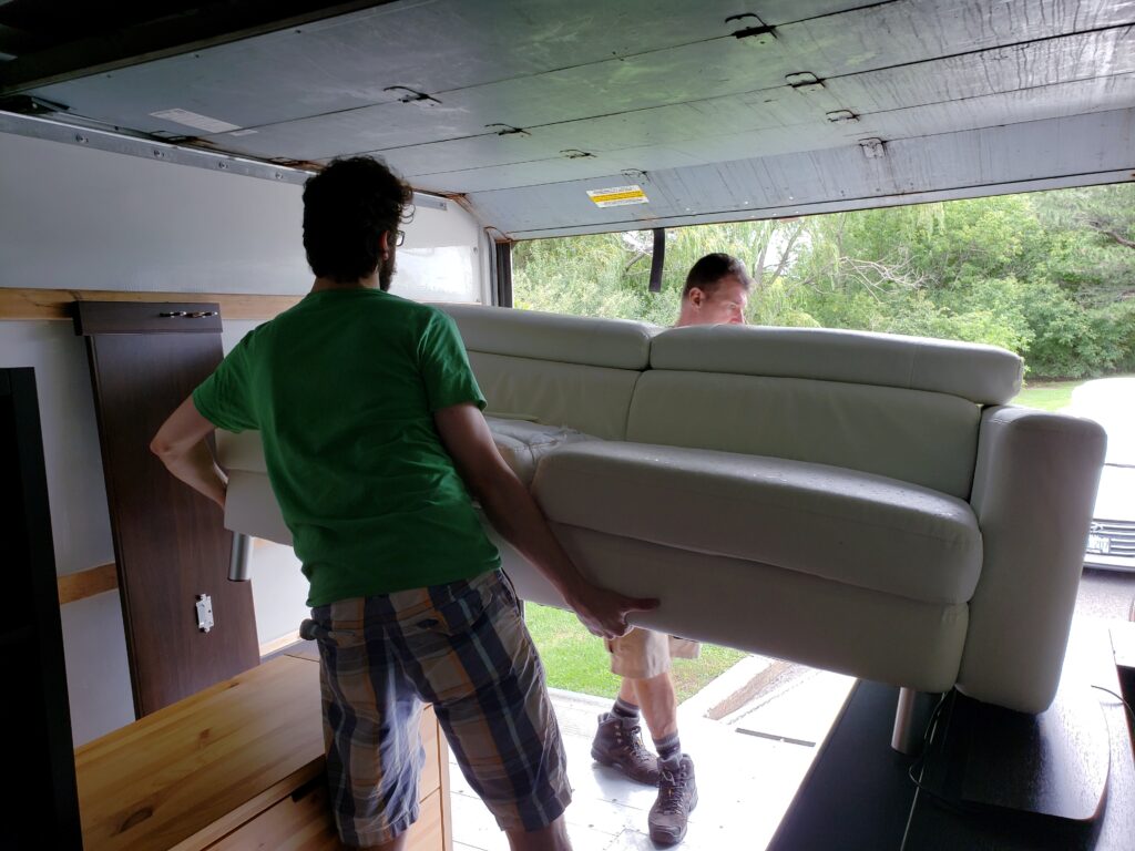 two men carrying a couch