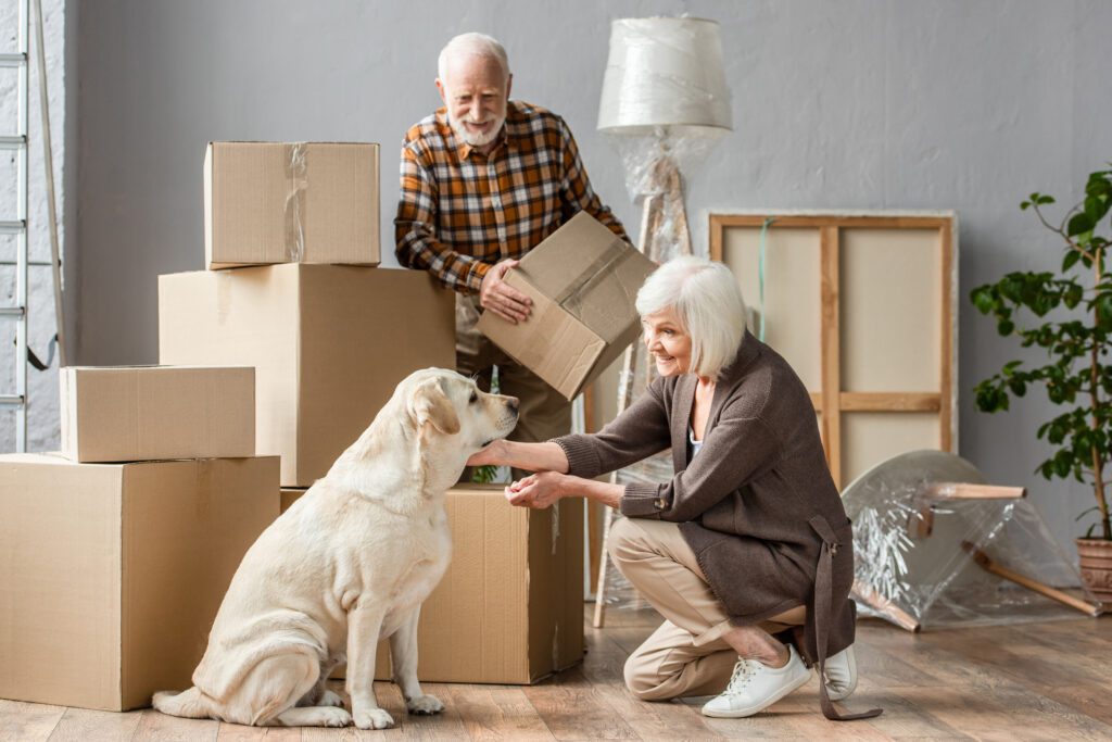 an elderly couple dotting on their dog