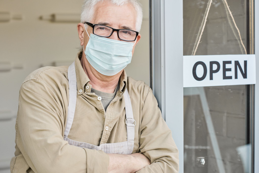 A business owner infront of his shop