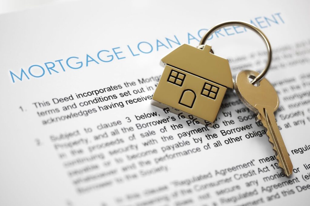 key to a home on top of a mortgage loan agreement