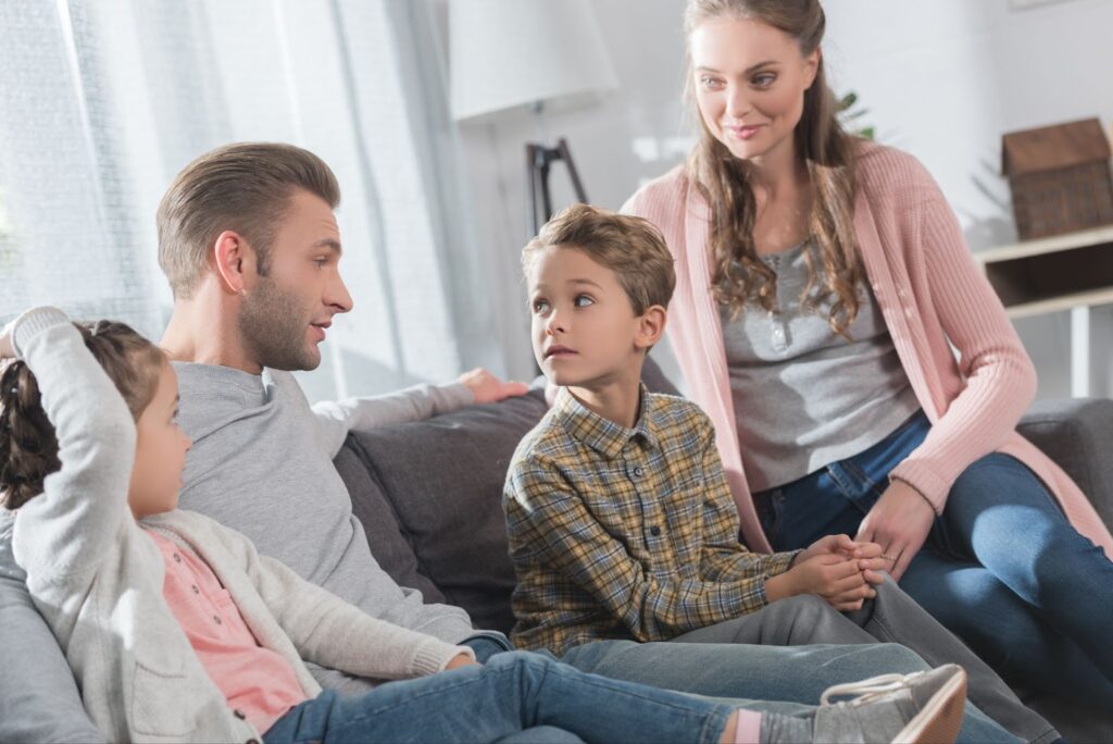 a father talking to his young children 