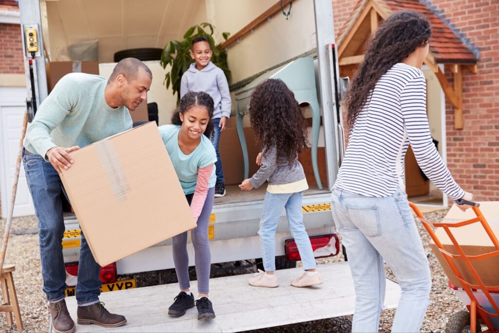A family unloading their moving truck